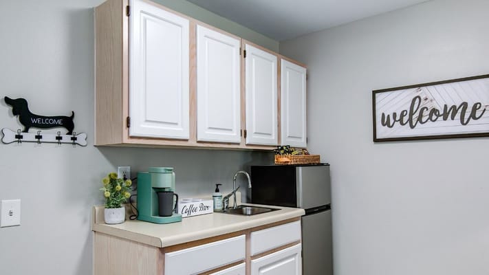 Bright kitchen area with modern decor and coffee station