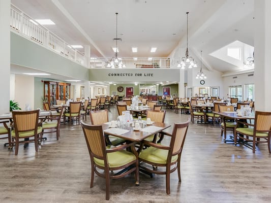 Bright dining area with tables and chairs arranged