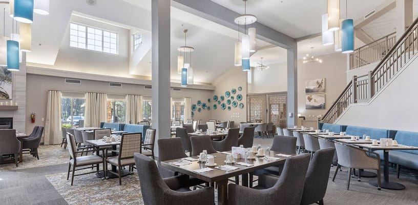 Bright and welcoming dining room with set tables