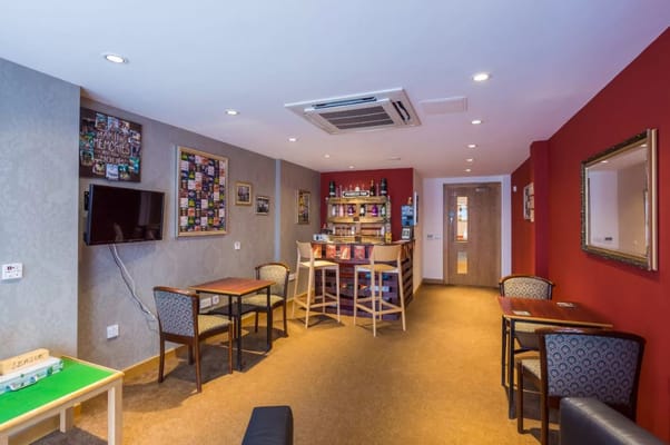 Interior view of a social area with seating and a bar.