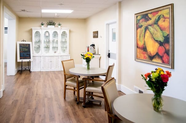 Interior view of a common area with flowers and a painting