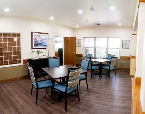 Bright common area with tables and chairs in a facility