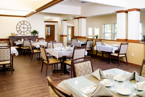 Dining room with neatly set tables and decor