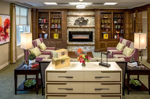 Stylish living room with seating, decorative shelves, and modern decor.
