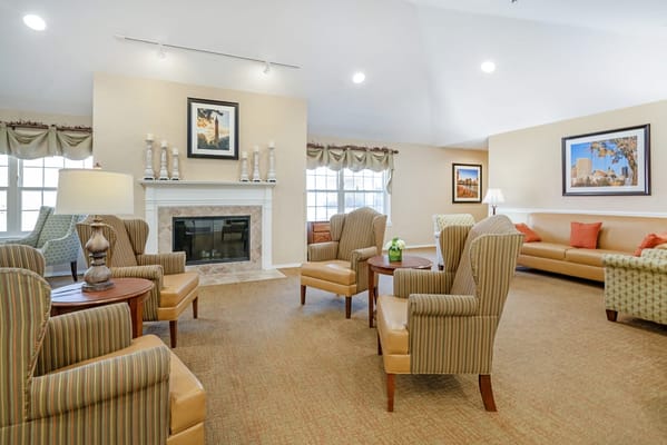 Bright common area with seating and fireplace