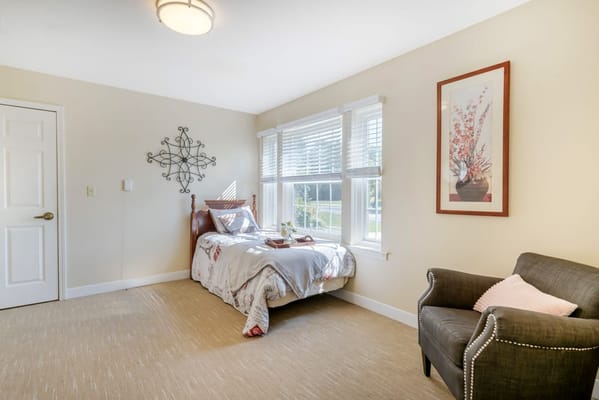 Cozy resident room with a bed and chair