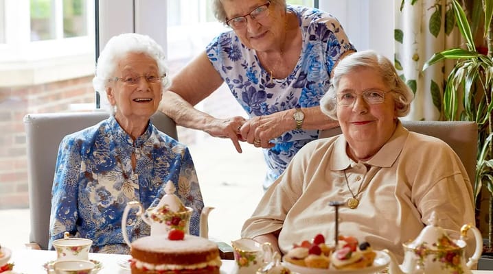 Residents enjoying tea and cake during a celebration