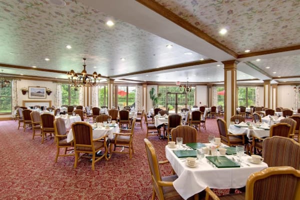 Spacious dining room with tables set for meals at Barrington of West Chester.