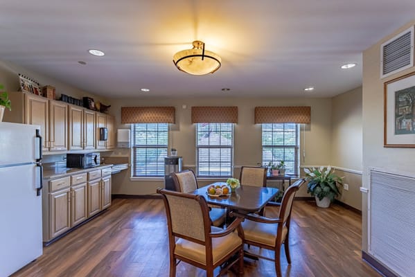A bright kitchen with dining area at Bear Creek Assisted & Senior Living.