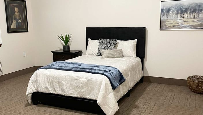 Cozy private resident room with a bed and artwork