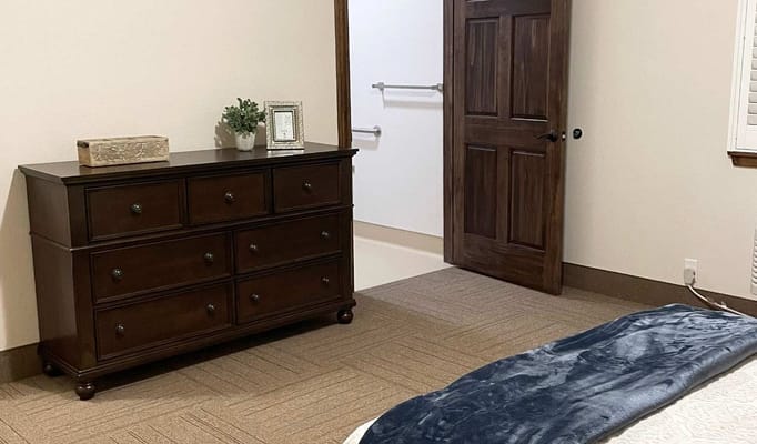 Cozy bedroom with a dresser and door