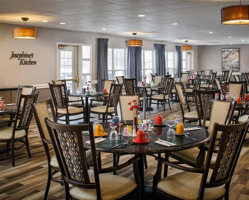 Dining room setup with tables and chairs at Belmont Village