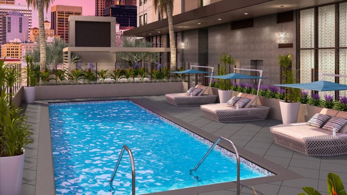 Outdoor pool area with lounge chairs and palm trees