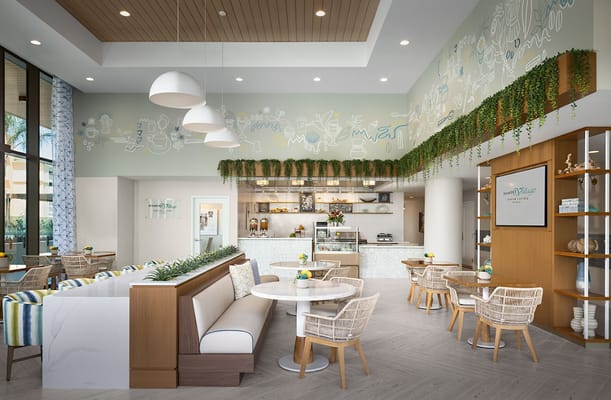 Bright and modern cafe interior with seating and greenery