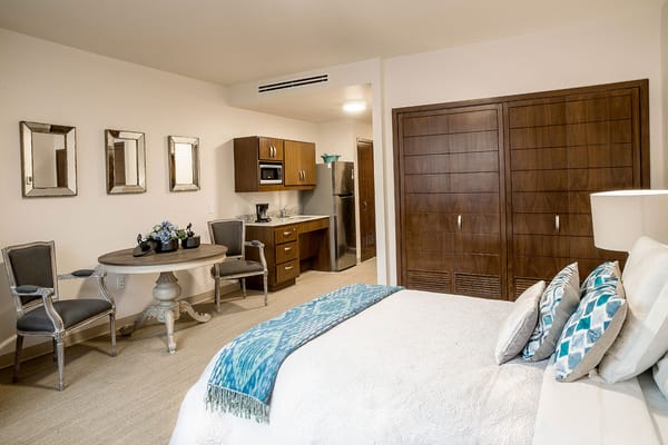 Stylish resident room with kitchenette and dining area