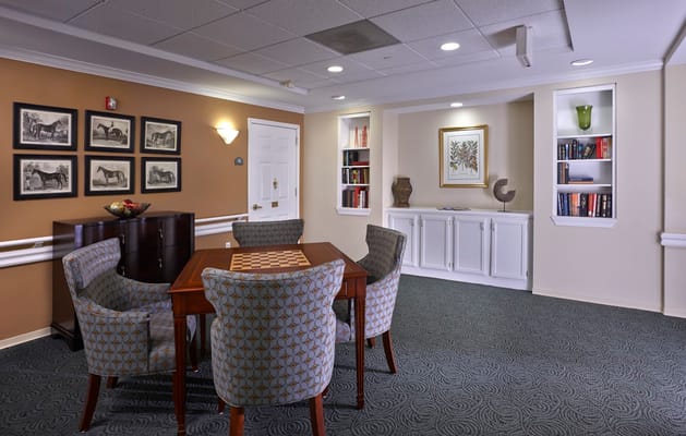 A cozy common area with seating and bookshelves