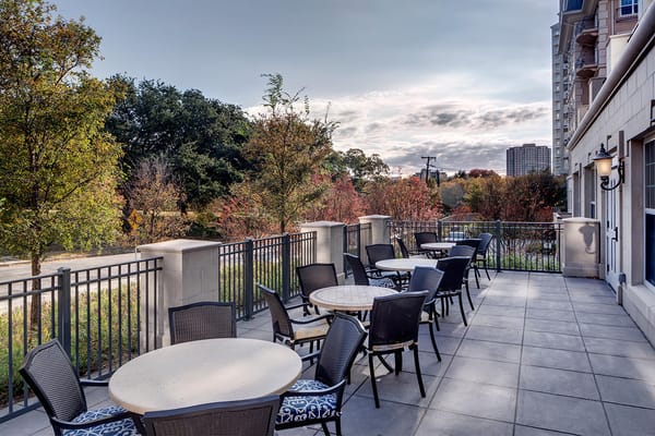 Outdoor patio area with seating and greenery