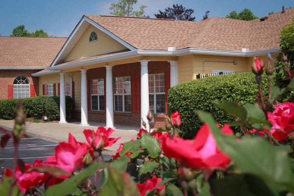 Exterior view of the facility with blooming roses