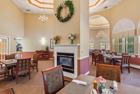 Bright dining area with floral decorations and fireplace