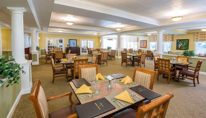Bright dining room with tables set for a meal