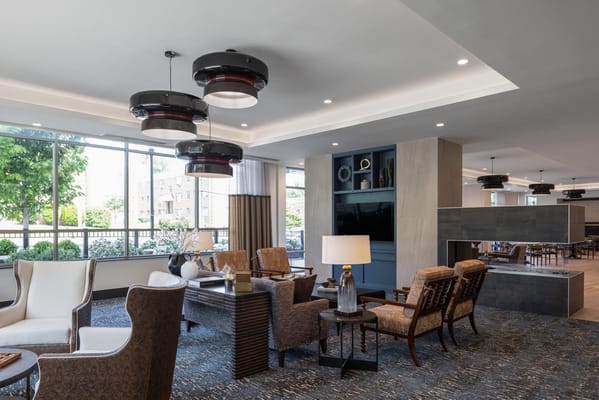 Modern interior of a senior living common area with seating
