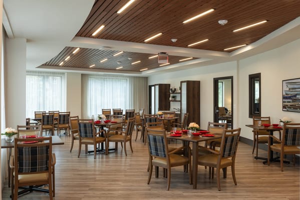 Bright dining area with tables and chairs set up
