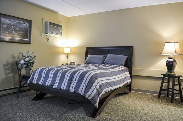 A cozy private resident room with a bed and decor