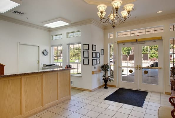 Bright lobby area with reception desk and seating
