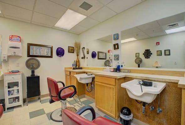 Hair salon area with barber chairs and mirrors