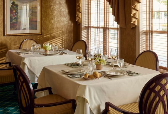 Elegant dining room setup with table settings and natural light