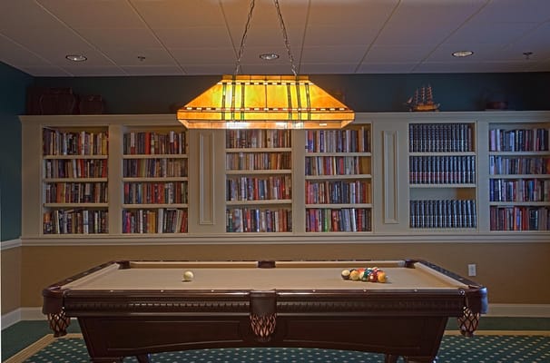 Interior with a pool table and bookshelves