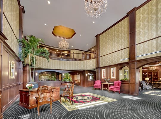 Spacious and beautifully decorated lobby with chandeliers and seating areas.