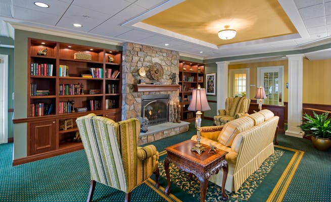 Cozy common area with bookshelves and a fireplace