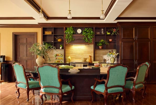 A cozy dining area with vintage chairs and decorative plants