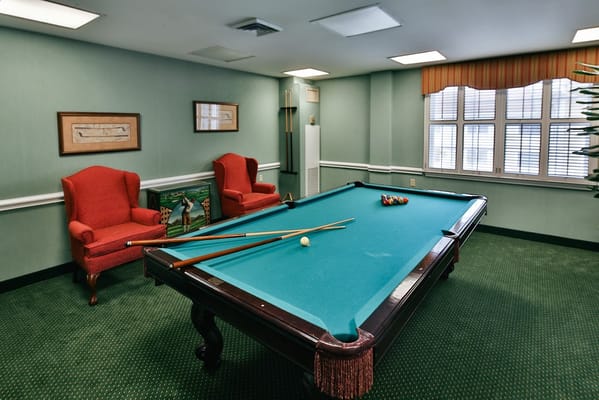 Billiards room with a pool table and seating
