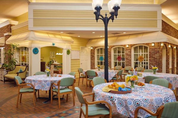 Dining area with decorated tables and fresh fruit