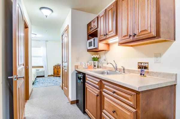 Interior view of a senior living unit kitchen area