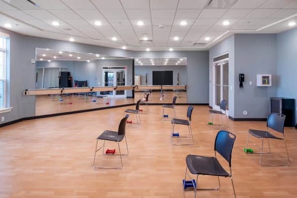 Empty activity room with chairs and weights