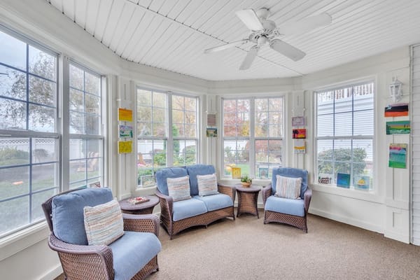 Bright, inviting sunroom with comfortable seating