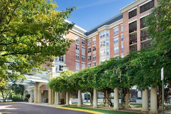Exterior view of Brighton Gardens with landscaped entrance