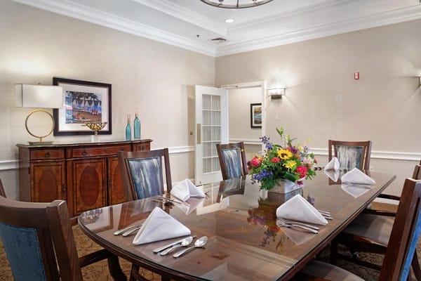 Elegant dining room setup with flowers and table settings