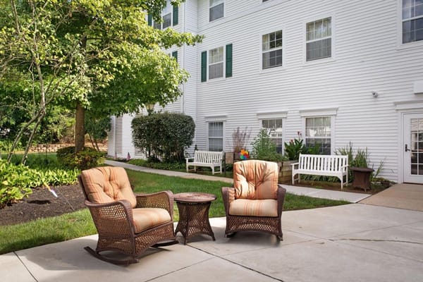 Outdoor seating area with rocking chairs and tables