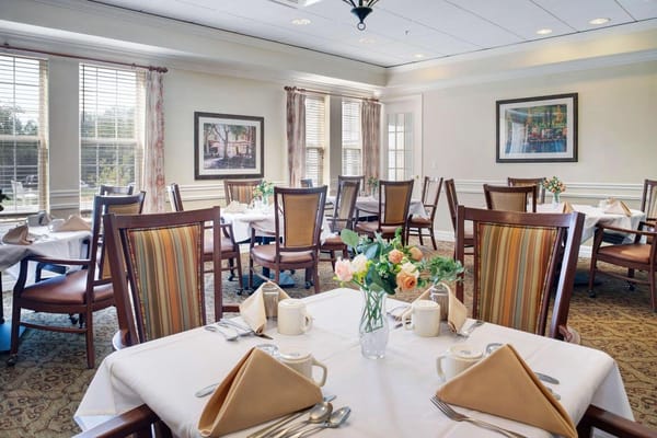 Well-set dining room with tables and floral arrangements