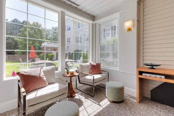 Bright sunlit lounge area with view of outdoor garden