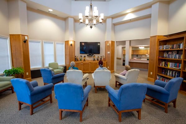 Residents relaxing in a common area with a TV