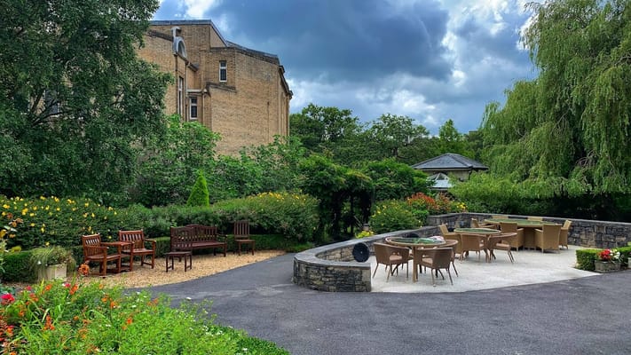 Outdoor seating area with garden and trees