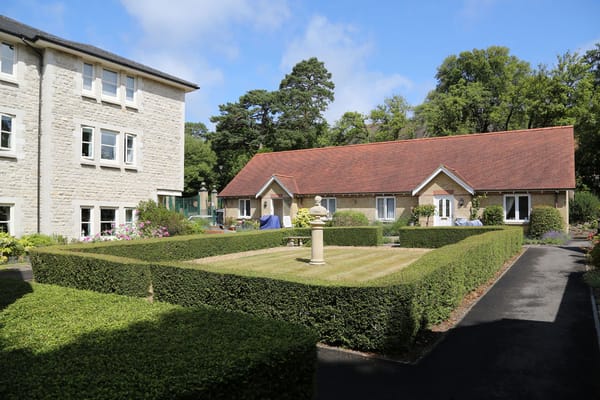 Outdoor garden area with manicured hedges