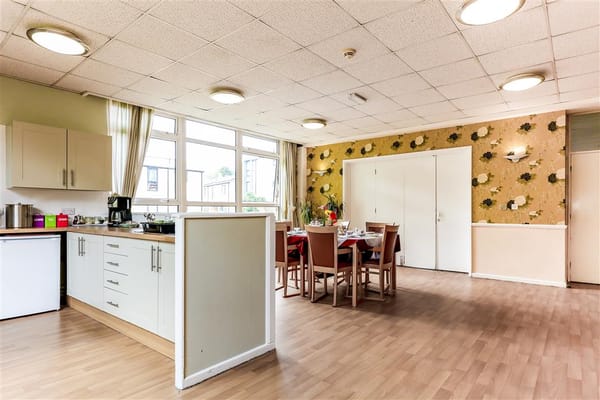 Bright dining room with tables set for meals