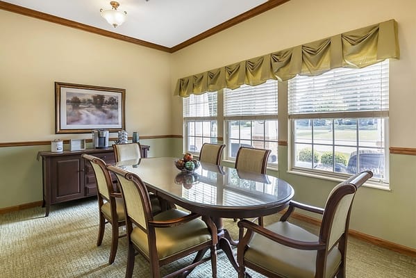 Bright common area with a dining table and chairs