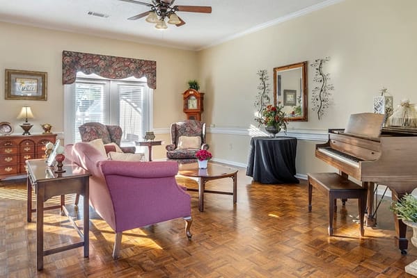 Well-furnished lounge area with seating and a piano